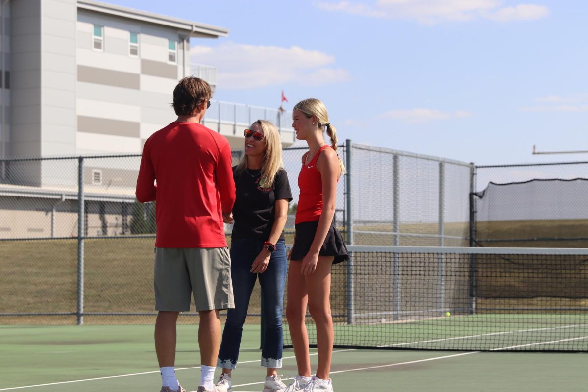 Senior Sydney Suiter and her mom speak to Coach Bergeron as he congratulates her.