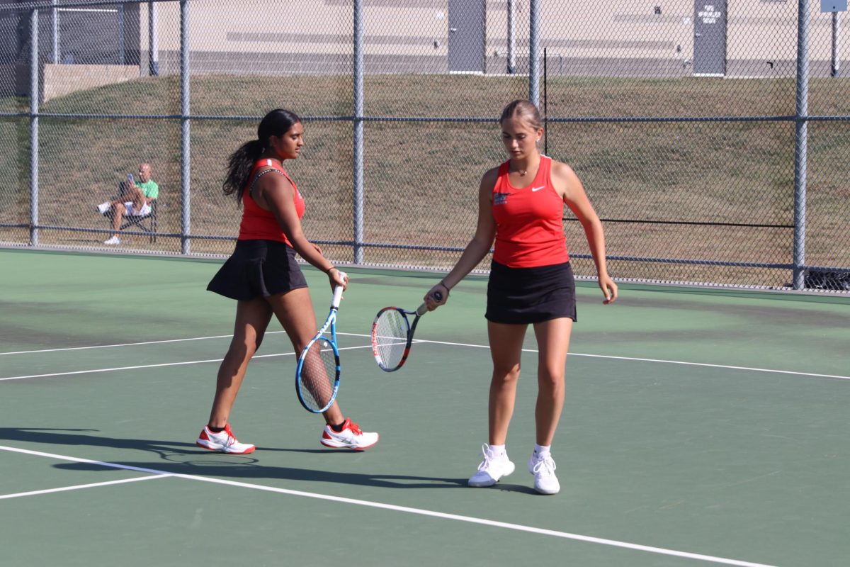 Seniors Jaylee Soule and Kavya Parikh hit rackets together as they just got a point against opponents.