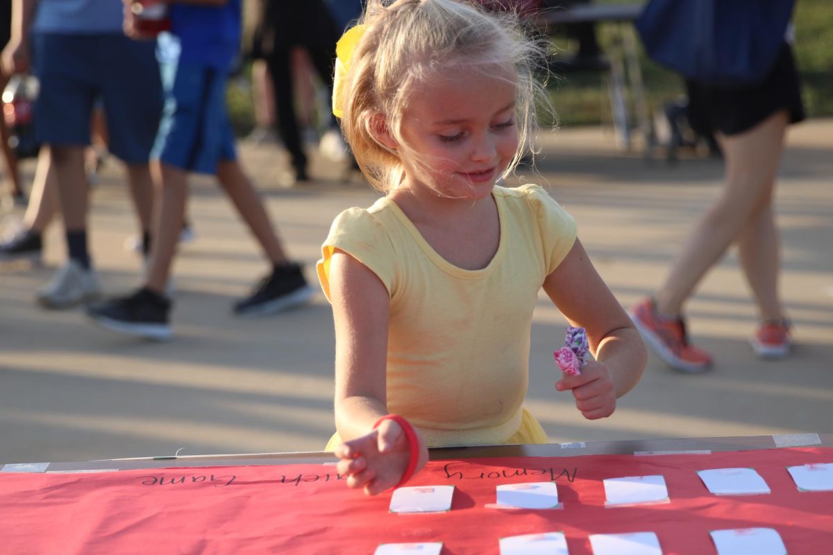 A little girl plays the matching game at the global connection booth
