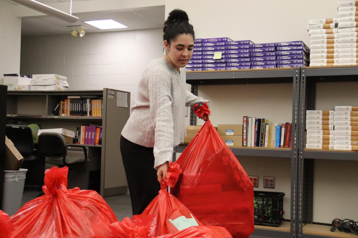 Senior Samantha Souan brings her Advisory classes Red Bag to the drop off area.