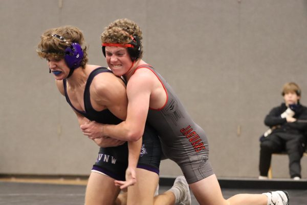 Freshman Carson Fowles attempts to bring his competitor to the mat