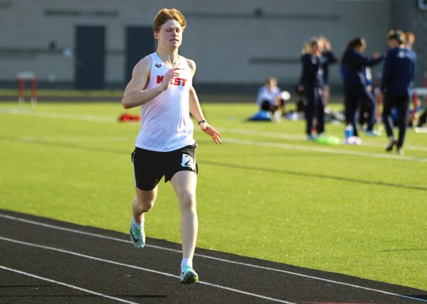 Junior Tate Miller sprints the last 25 yards of the 200 meter race.
