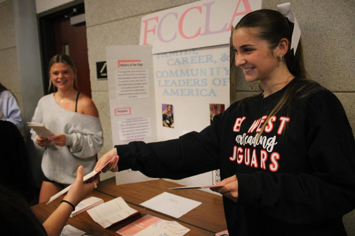 A member of FCCLA handing out flyers to interested students.