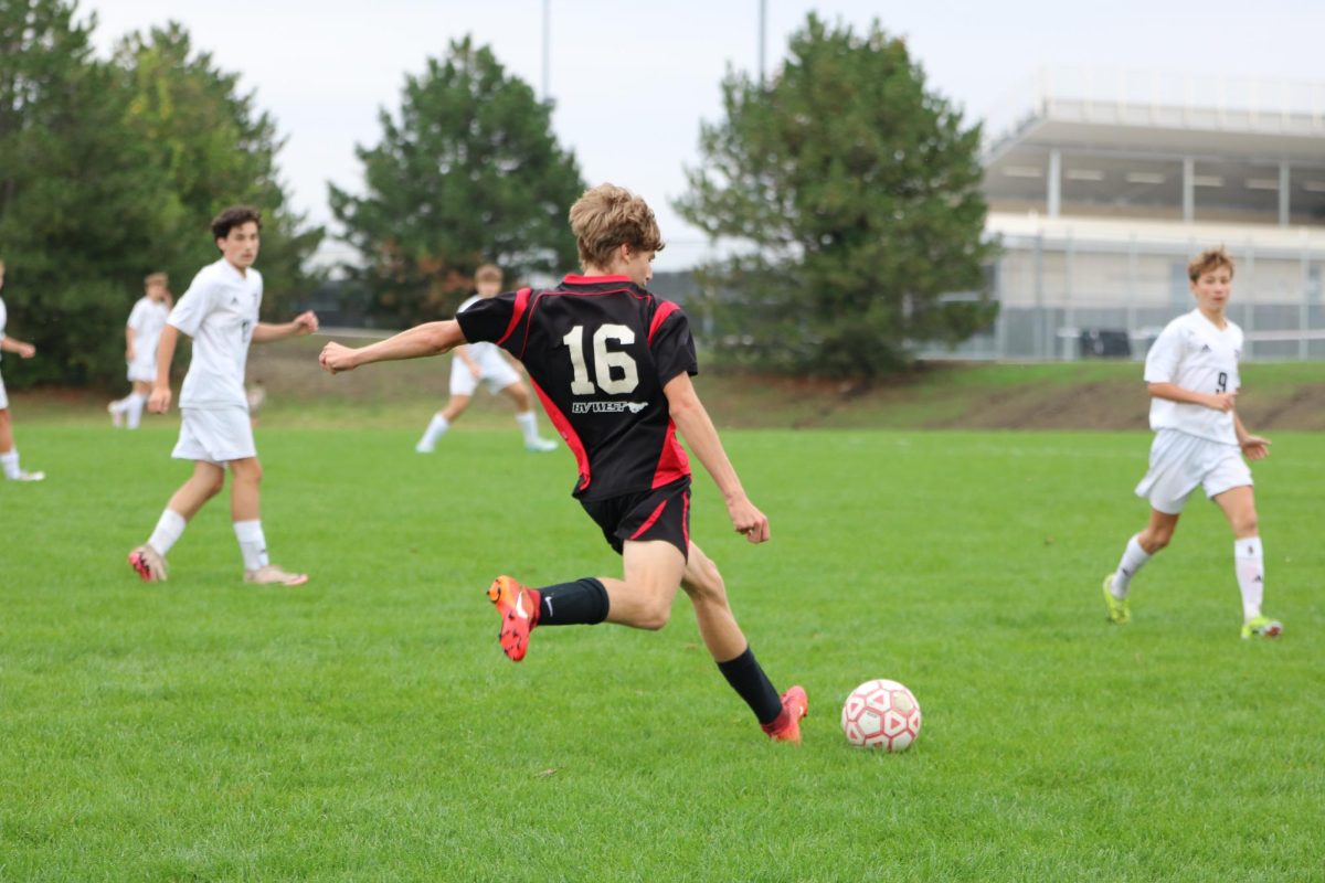 Sophomore Braxon Blunck about to pass the ball to another jag player. 