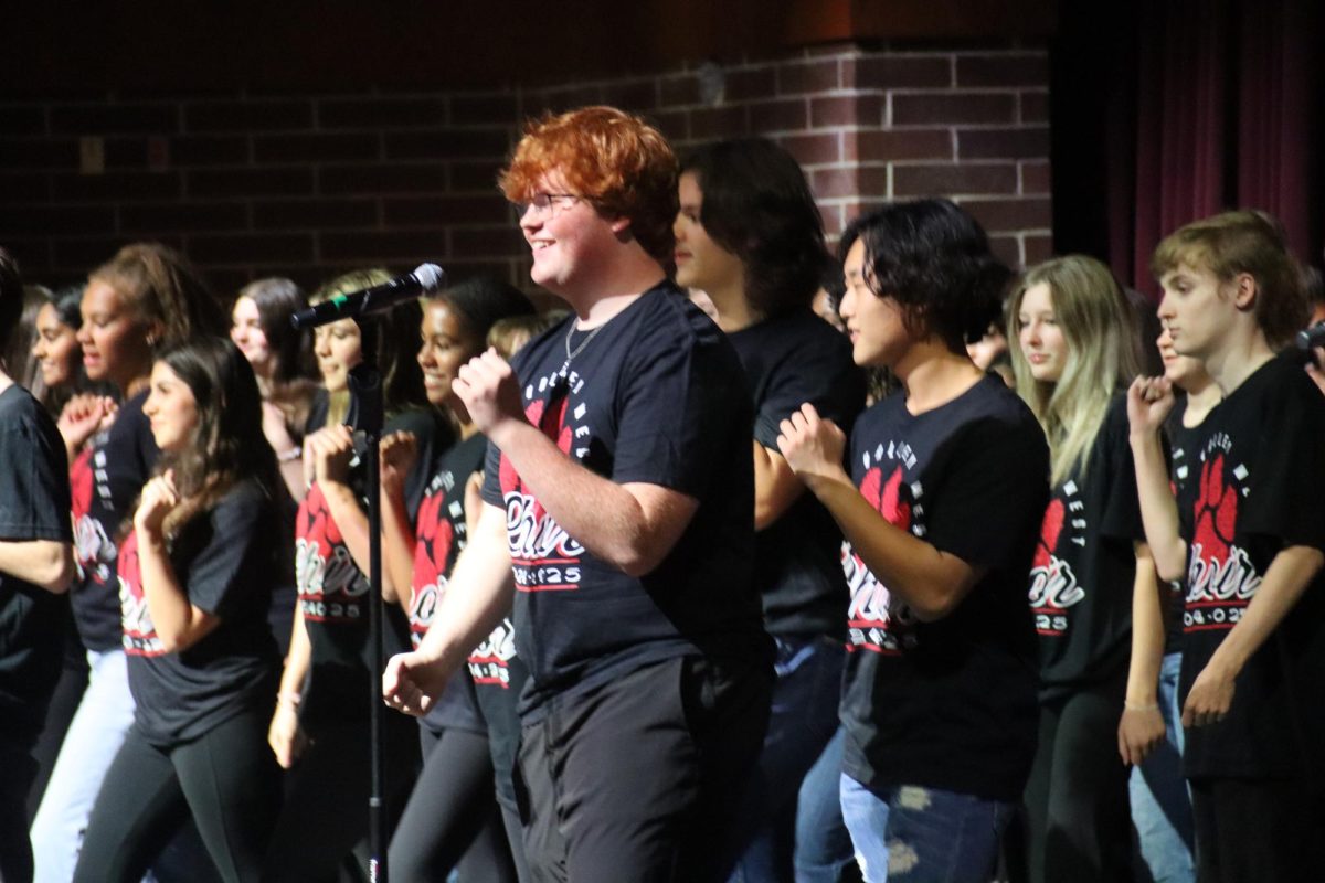 Junior Wesley Kratochvil sings his solo during the choirs performance 