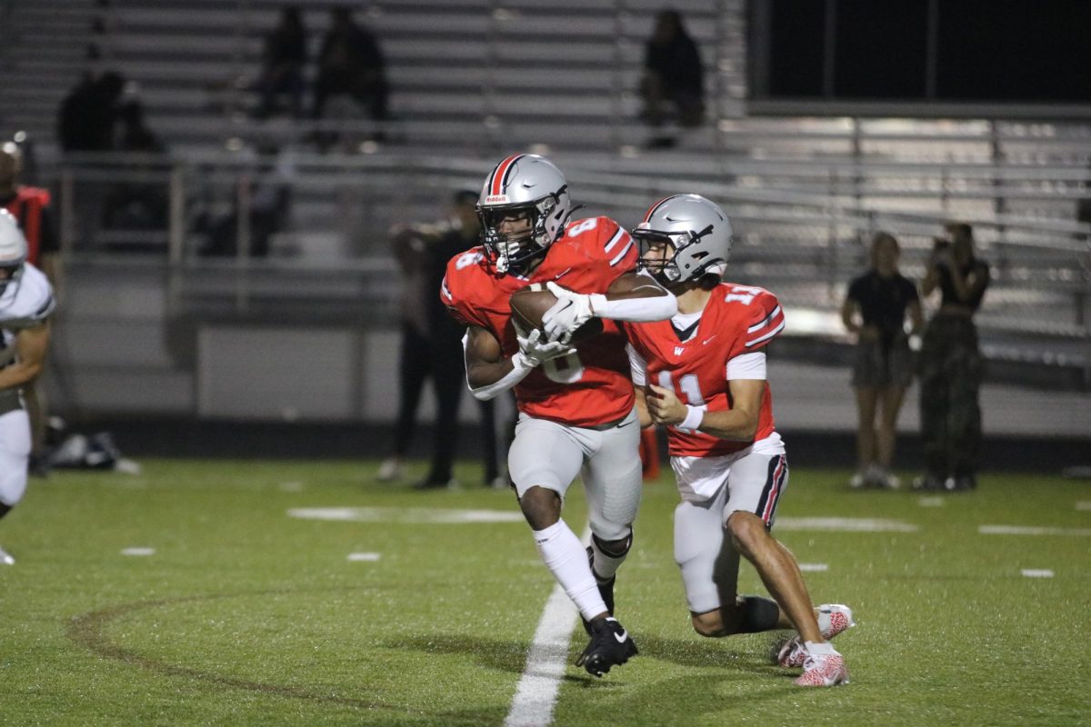 Senior Tate Nagy hands the ball off to Senior Wade Carter