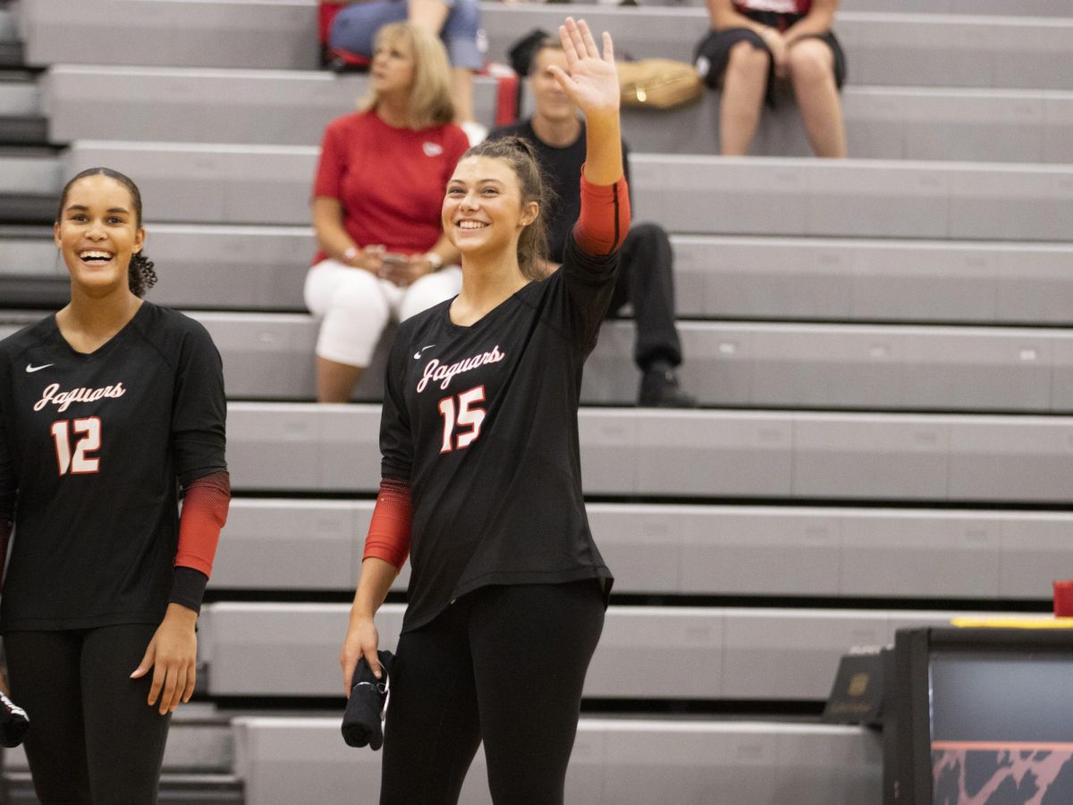 Senior Hanna Lee Willeford waves to the crowd at the beginning of their match.