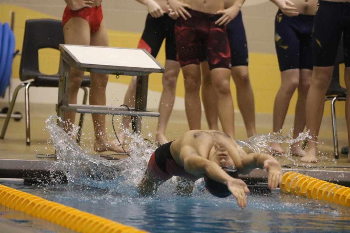 Senior Laksh Saluja does a backstroke start.