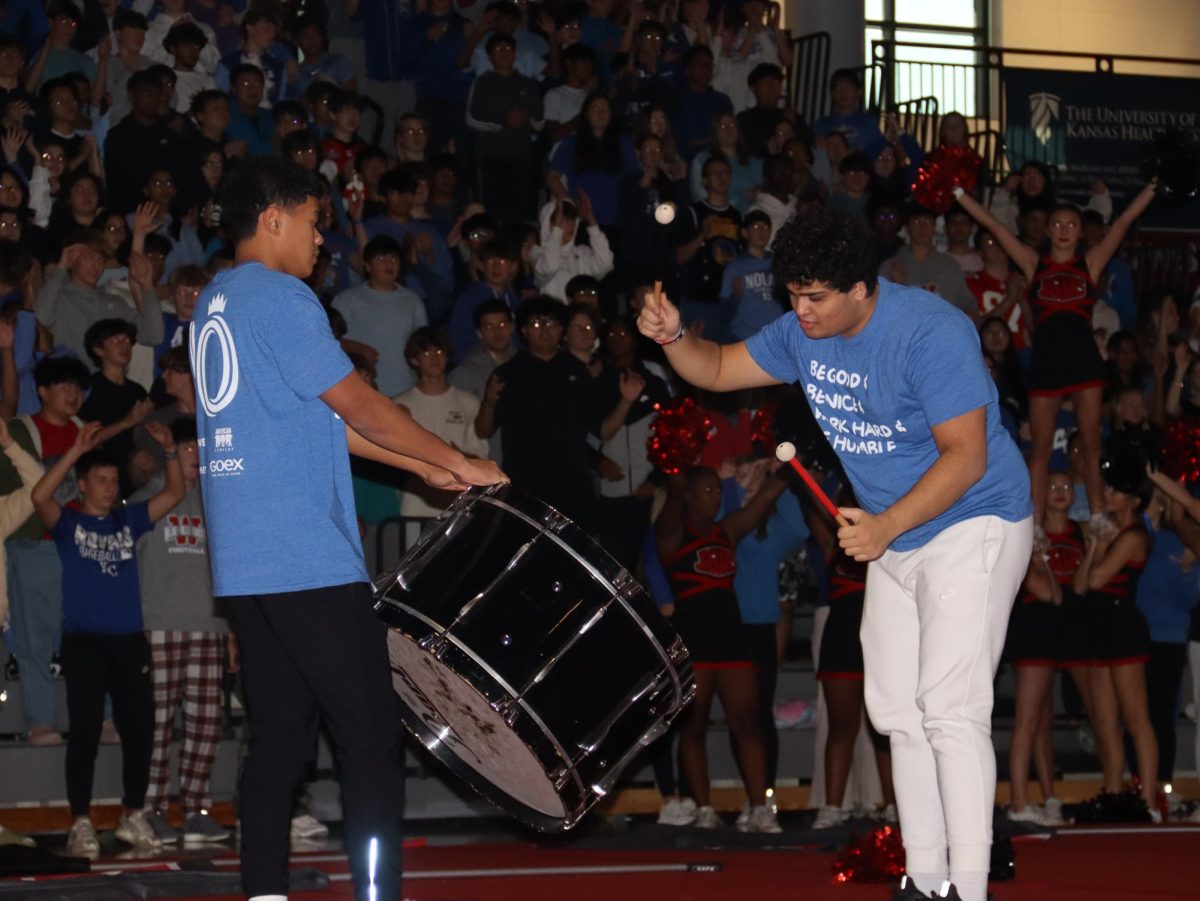 Seniors Jacob Morgan and Aayush Phadnis open the assembly with hitting the JPCO drum 