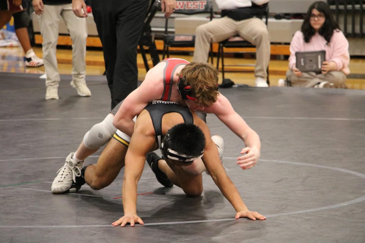 Junior Scott Fohlmeister wrestles with opponent. 