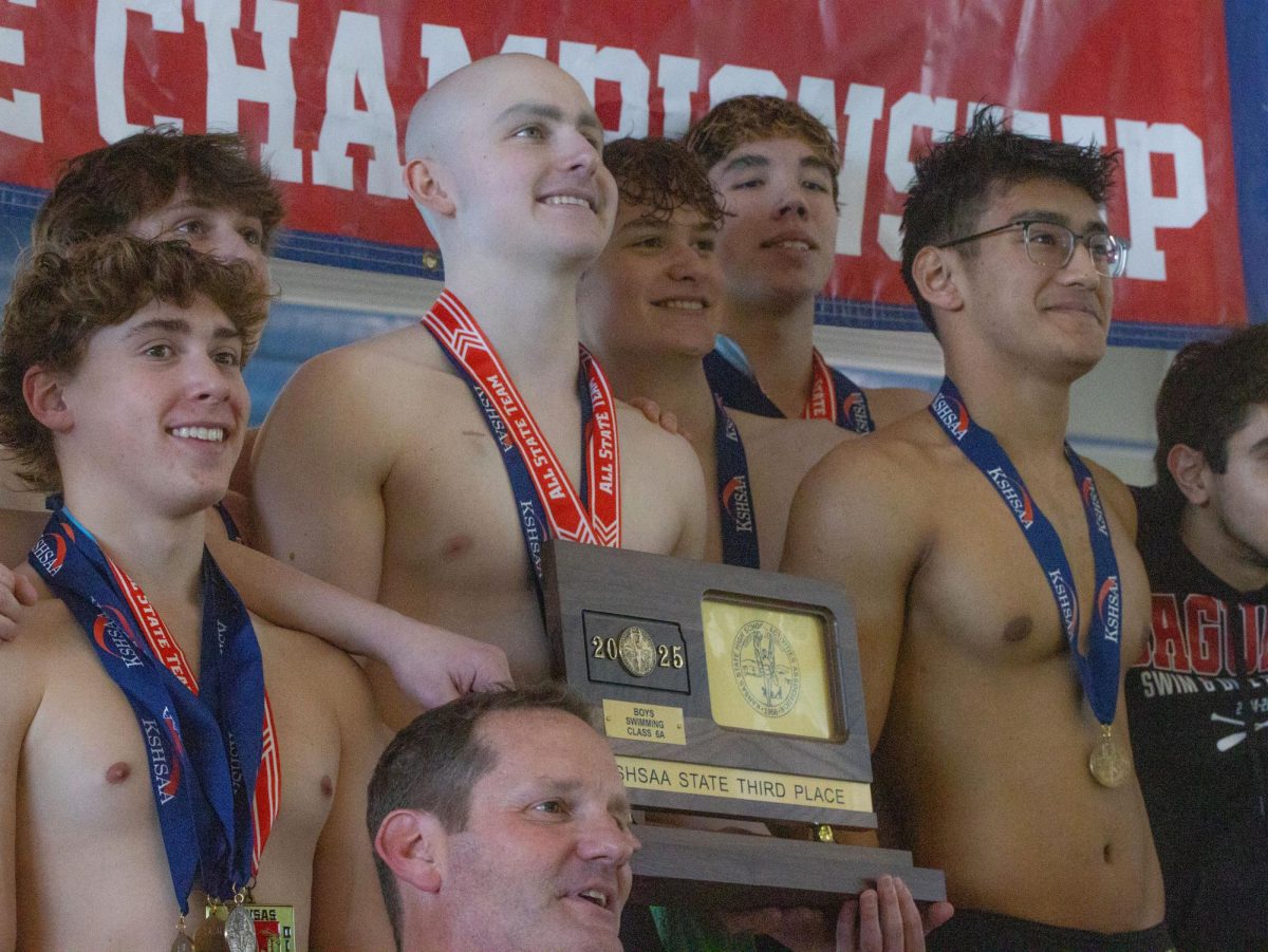 The boys swim team celebrates their third place finish at state