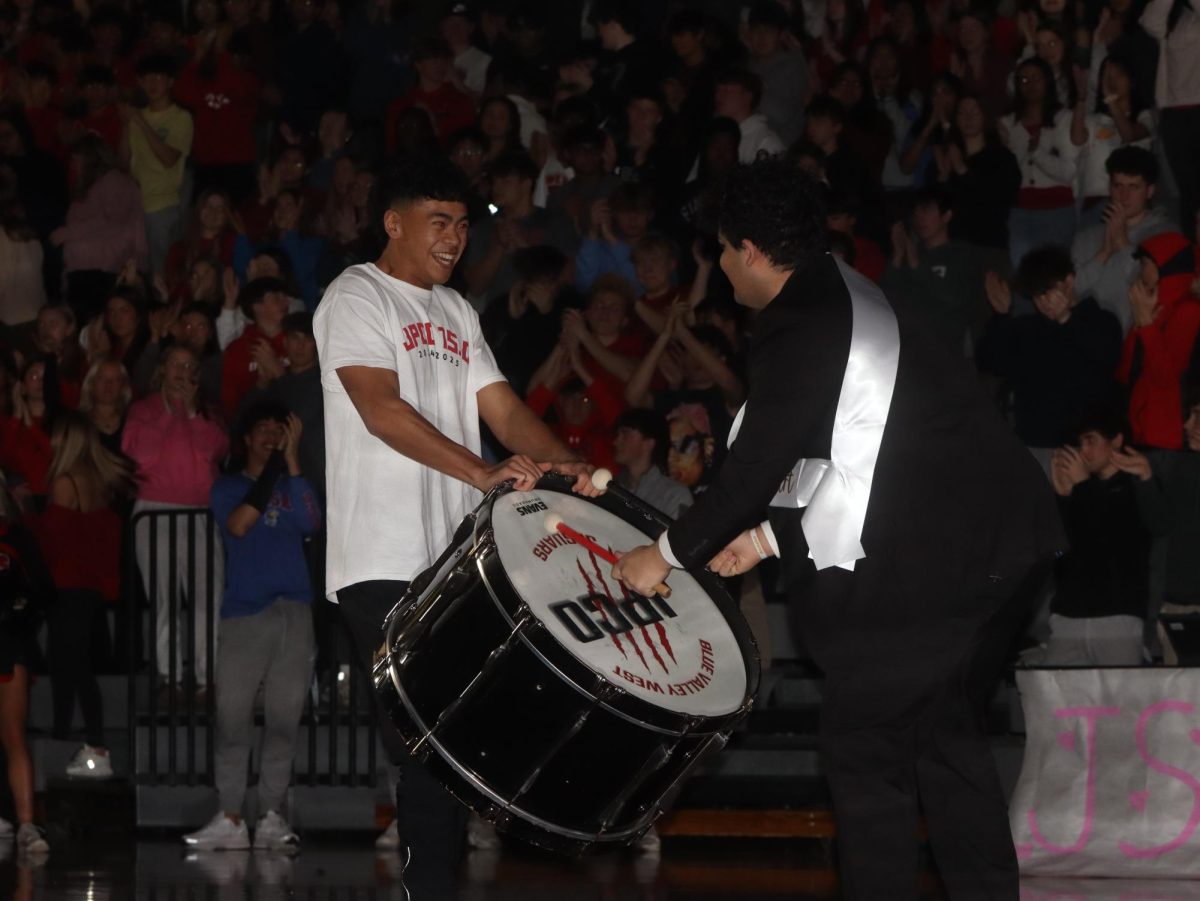 Seniors Jacob Morgan and Aayush Phadnis kick off the assembly with hitting the drum