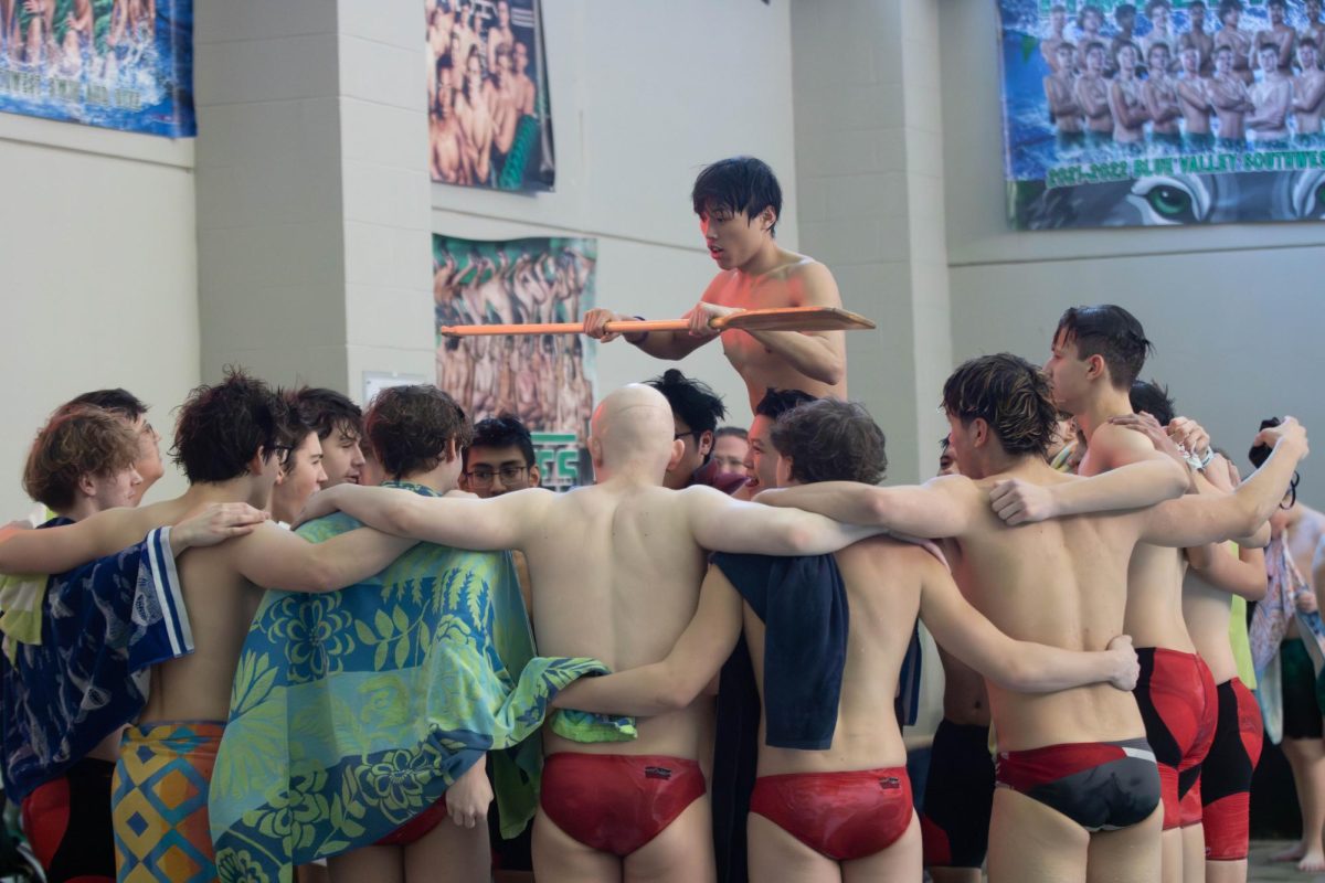 The boys swim team does their pre meet ritual of "Row the Boat" 