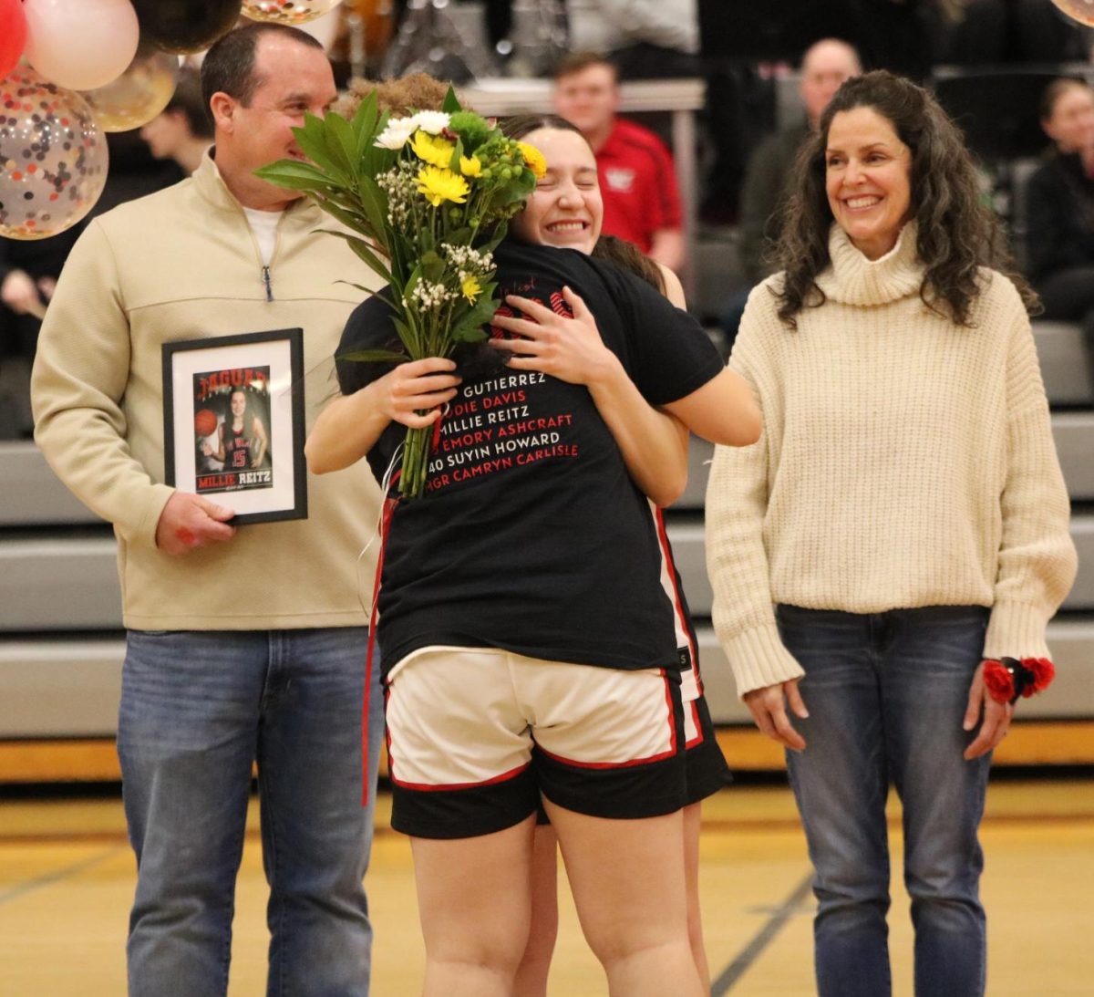 Senior Millie Reitz gives a big hug to an underclassman.