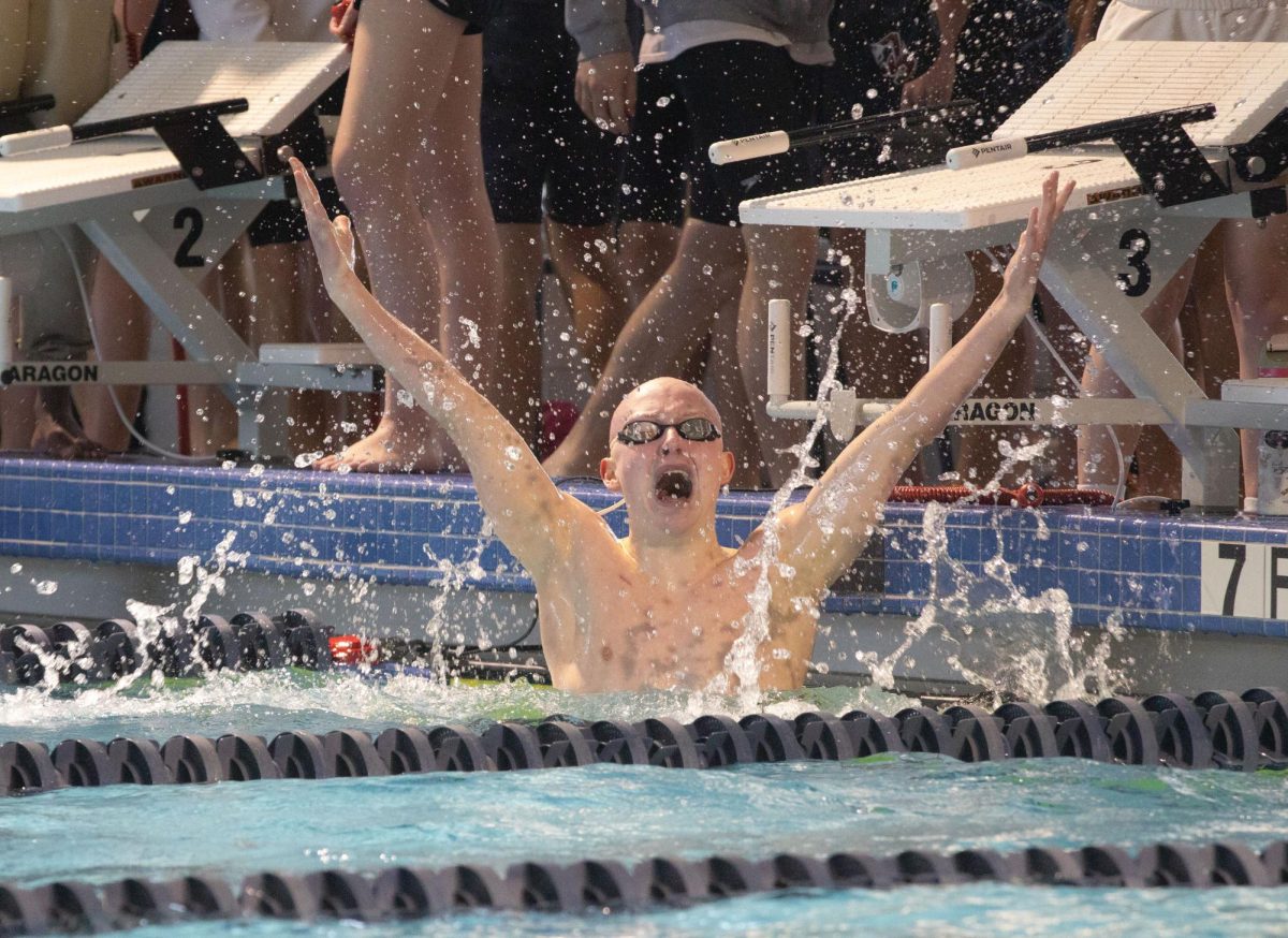 FIGHTING FOR THE WIN…
Blue Valley West senior Jack Punswick throws his hands in the air to celebrate his win in the 100-yard breaststroke at the Shawnee Mission Invitational. 